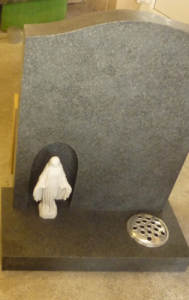 Granite headstone with inset stone carving Granite headstone with inset stone carving